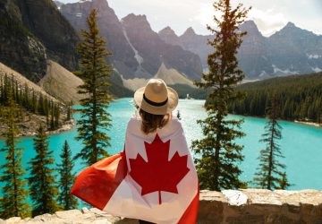 A University Student with the Canadian Flag wrapped around her